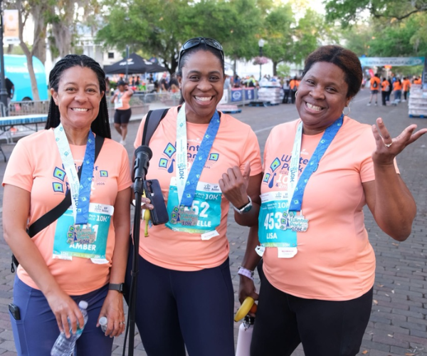 Three ladies standing cheerfully after a run